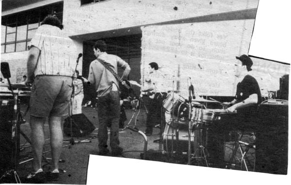 Photo of The Black Assassins  performing in the 4ZZZ carpark, Queensland University, Brisbane 1983.